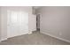 This bedroom features a carpet floor and a large closet with sliding doors at 22895 N 183Rd Dr, Surprise, AZ 85387