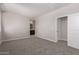 This spacious bedroom features neutral walls, plush carpeting, and an ensuite bathroom at 22895 N 183Rd Dr, Surprise, AZ 85387