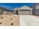 Charming single-story home with a two-car garage, desert landscaping, and a neutral color palette at 22895 N 183Rd Dr, Surprise, AZ 85387