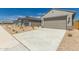 Attractive home with a two-car garage, xeriscaping, and a well-kept driveway on a sunny day at 22895 N 183Rd Dr, Surprise, AZ 85387
