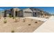 Inviting single-Gathering house showcasing desert landscaping, a well-maintained lawn, and a community street at 22895 N 183Rd Dr, Surprise, AZ 85387