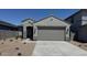 Charming single-story home featuring desert landscaping and a neutral color palette at 22895 N 183Rd Dr, Surprise, AZ 85387