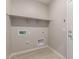 Functional laundry room with a shelf, offering practicality and storage solutions at 22895 N 183Rd Dr, Surprise, AZ 85387
