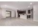 Open floor plan showcasing wood-style tile flooring and a seamless transition from living area to kitchen at 22895 N 183Rd Dr, Surprise, AZ 85387