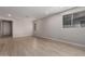 Bright living space with modern wood-look tile flooring, neutral paint, and multiple windows at 22895 N 183Rd Dr, Surprise, AZ 85387