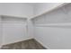 This walk-in closet features carpet flooring and a wooden clothes rack at 22895 N 183Rd Dr, Surprise, AZ 85387