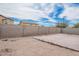 Generous backyard with a concrete patio, block wall, and a patch of dirt at 23613 W Mobile Ln, Buckeye, AZ 85326