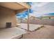 Large backyard with a concrete patio, block wall, and sunny blue skies at 23613 W Mobile Ln, Buckeye, AZ 85326