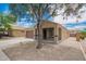 Charming single-story home featuring a desert-landscaped yard and covered porch area at 23613 W Mobile Ln, Buckeye, AZ 85326