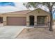Cozy single-story home featuring a desert-landscaped yard, covered porch, and two-car garage at 23613 W Mobile Ln, Buckeye, AZ 85326