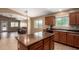 Spacious kitchen with a center island, stainless steel sink, and dark appliances at 23613 W Mobile Ln, Buckeye, AZ 85326
