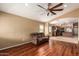 Comfortable living room with dark wood floors and a view into the adjacent kitchen at 23613 W Mobile Ln, Buckeye, AZ 85326