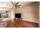 Spacious living room featuring wood floors, a ceiling fan, and an open floor plan at 23613 W Mobile Ln, Buckeye, AZ 85326
