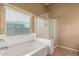 Bright main bathroom featuring a large tub, and a window at 23613 W Mobile Ln, Buckeye, AZ 85326