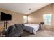 Bright main bedroom featuring a window, and an accent chair at 23613 W Mobile Ln, Buckeye, AZ 85326