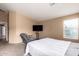 Bright main bedroom featuring a window, and an accent chair at 23613 W Mobile Ln, Buckeye, AZ 85326