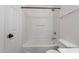 This bathroom features a tub-shower combo with white tiling and modern fixtures at 2518 W Carson Rd, Phoenix, AZ 85041