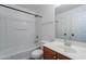This bathroom features a shower-tub combo, single sink vanity, and neutral color palette at 2518 W Carson Rd, Phoenix, AZ 85041