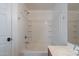 All-white bath and shower featuring a tub with showerhead and plenty of shelving for storage at 2518 W Carson Rd, Phoenix, AZ 85041