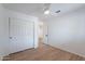 Bright bedroom with wood-look floors, ceiling fan and closet at 2518 W Carson Rd, Phoenix, AZ 85041