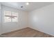 Bedroom with wood-look floors and neutral walls has a window for natural light at 2518 W Carson Rd, Phoenix, AZ 85041
