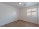 Bedroom featuring laminate floors, neutral walls, and a window for lots of natural light at 2518 W Carson Rd, Phoenix, AZ 85041