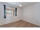 Bedroom with wood-look floors, fan, neutral walls and window with curtains at 2518 W Carson Rd, Phoenix, AZ 85041