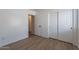 Bedroom with wood-look floors and a closet near the doorway at 2518 W Carson Rd, Phoenix, AZ 85041