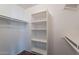 Walk-in closet with built in shelves and clothes hanging rods at 2518 W Carson Rd, Phoenix, AZ 85041