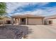 Charming single-story home with a low-maintenance desert-style front yard and a two-car garage at 2518 W Carson Rd, Phoenix, AZ 85041