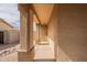 Covered front porch with stone columns, security door, and gravel landscaping at 2518 W Carson Rd, Phoenix, AZ 85041
