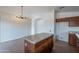 Bright kitchen features a granite island, tile floors, and a modern chandelier at 2518 W Carson Rd, Phoenix, AZ 85041
