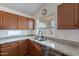 Beautiful kitchen with stainless steel appliances, a double sink, and granite countertops at 2518 W Carson Rd, Phoenix, AZ 85041