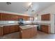 Kitchen with stainless steel appliances, island with granite countertops, and ample wooden cabinets at 2518 W Carson Rd, Phoenix, AZ 85041