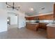 Open kitchen features tile floors, an island with granite countertops, and ample wood cabinets at 2518 W Carson Rd, Phoenix, AZ 85041
