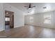 Inviting living room with wood-look floors, ceiling fan, and a view into other rooms at 2518 W Carson Rd, Phoenix, AZ 85041