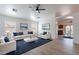 Well-lit living room featuring hardwood floors, a ceiling fan, and an open floor plan at 2518 W Carson Rd, Phoenix, AZ 85041