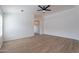 Bright living room showcasing wood-look floors, a ceiling fan, and versatile neutral paint at 2518 W Carson Rd, Phoenix, AZ 85041