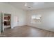 Bright, open living room with wood-look floors and natural light from a window and back patio door at 2518 W Carson Rd, Phoenix, AZ 85041