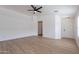 Spacious living room with hardwood floors, ceiling fan, and neutral paint at 2518 W Carson Rd, Phoenix, AZ 85041