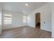 Bright main bedroom with hard surface floors, neutral paint, and an ensuite bathroom entrance at 2518 W Carson Rd, Phoenix, AZ 85041