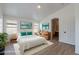 Staged main bedroom with art and an ensuite bathroom entrance at 2518 W Carson Rd, Phoenix, AZ 85041