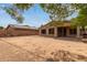A spacious backyard, with a covered patio and a gas grill, offers a private outdoor space at 2590 S Buckaroo Trl, Gilbert, AZ 85295