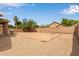 Spacious backyard with gravel landscaping and privacy fence, providing a low-maintenance outdoor area at 2590 S Buckaroo Trl, Gilbert, AZ 85295