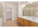 Bathroom featuring a double sink vanity, tile floors, and a glass shower at 2590 S Buckaroo Trl, Gilbert, AZ 85295