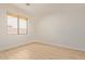 This bright bedroom features neutral tones, wood-look floors, and a window with window coverings at 2590 S Buckaroo Trl, Gilbert, AZ 85295