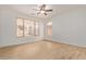 Bright bedroom with a ceiling fan and natural light at 2590 S Buckaroo Trl, Gilbert, AZ 85295