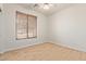 A bright bedroom offers neutral tones, wood-look floors, a ceiling fan and a window with blinds at 2590 S Buckaroo Trl, Gilbert, AZ 85295