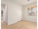 A clean bedroom features neutral tones, wood-look floors, a window with blinds, and a closet at 2590 S Buckaroo Trl, Gilbert, AZ 85295