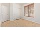 A bedroom features neutral tones, wood-look floors, window with blinds, and double door closet at 2590 S Buckaroo Trl, Gilbert, AZ 85295